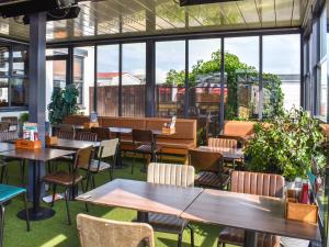 a restaurant with tables and chairs and windows at The Moon in Heysham