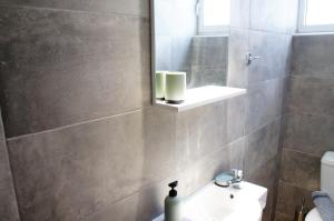 a bathroom with a sink and a mirror at A&I Apartments & Studios in Athens +21 photos