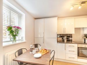 a kitchen and dining room with a wooden table and chairs at Raven Cottage in Barnard Castle