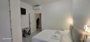 a white room with a couch and a table at Orchidea Stazione in Bologna +19 photos