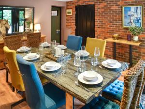 a dining room with a table and chairs at Shetland Cottage in Stalham