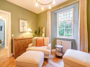 a living room with two chairs and a window at West Lodge in Perth