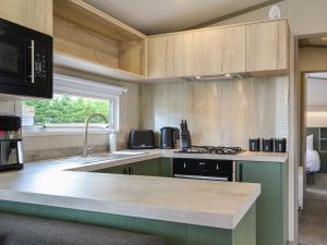 a kitchen with a sink and a counter top at Pine Meadows Retreat - Uk48919 in Wilberfoss +11 photos