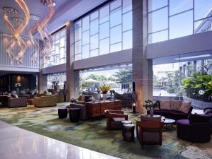 a lobby of a hotel with couches and chairs at Grand Mercure Bandung Setiabudi in Bandung