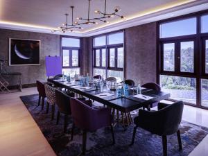a large dining room with a long table and chairs at Grand Mercure Bandung Setiabudi in Bandung +100 photos