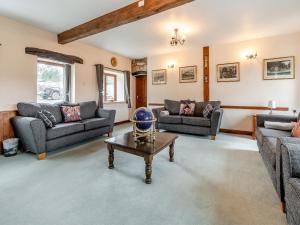 a living room with couches and a table at The Haybarn - Uk42935 in Rosedale Abbey