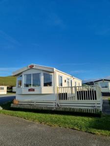 a white trailer sitting on the side of a road at Bayview at Pengarreg in Llanrhystyd