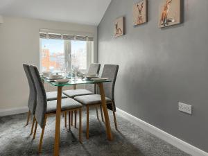 a dining room with a table with chairs and a window at Regent House in Scarborough