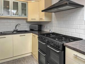 a kitchen with a stove top oven next to a microwave at Regent House in Scarborough