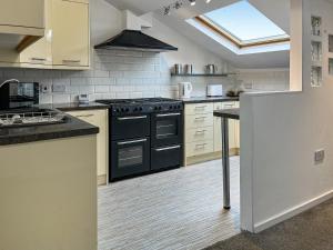 a kitchen with a black stove top oven at Regent House in Scarborough