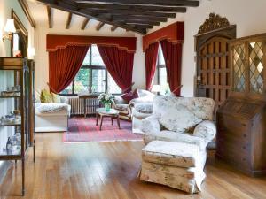 a living room with two chairs and a couch at The Sanctuary in Little Chart