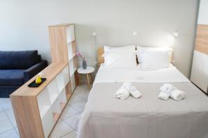 a bedroom with a bed with two slippers on it at A&I Apartments & Studios in Athens