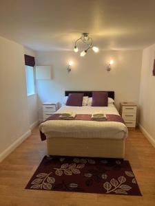 a bedroom with a large bed with a rug at Dunsdale Lodge in Frodsham
