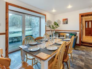 a dining room with a table and chairs at Balnamuir Farmhouse in Pitlochry