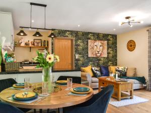 a living room with a table and a couch at The Retreat in Saint Leonards