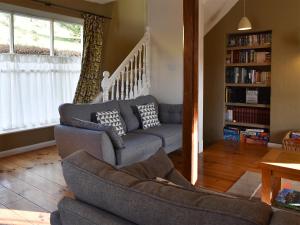 a living room with a couch and a chair at Letterbox Cottage in Far Sawrey