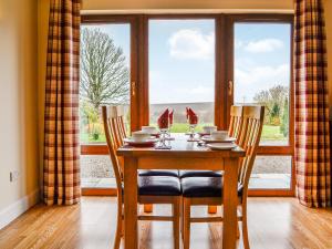 a dining room table with two chairs and a window at Woodside in Blairgowrie