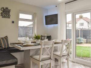 a dining room with a table and chairs and a window at Wharfdale Lodge in Thornton