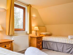 a bedroom with two beds and a window at Woodside in Blairgowrie +4 photos