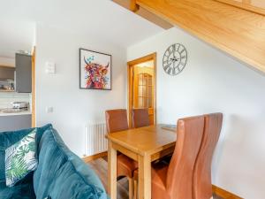 ein Wohnzimmer mit Tisch und Couch in der Unterkunft The Larches - Uk46804 in Culbokie