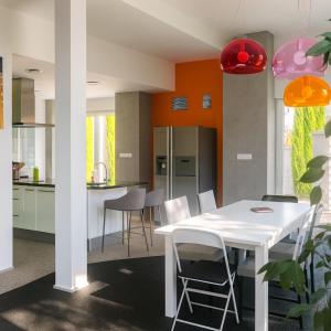 a kitchen with a white table and chairs at Villa Évasion Prestige in Brumath