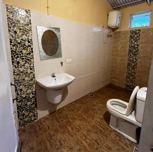 a bathroom with a toilet and a sink at The Big Cat's Den - Maravakandy Resort, Masinagudi in Masinagudi