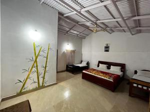 a bedroom with a bed and a couch in a room at The Big Cat's Den - Maravakandy Resort, Masinagudi in Masinagudi