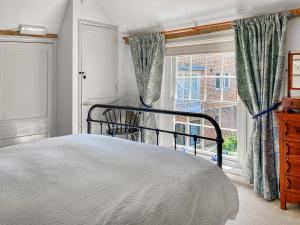 a bedroom with a bed and a window at The Friars Apartment, Eastbridge Hospital in Canterbury
