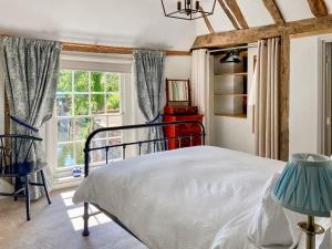 a bedroom with a bed and a window at The Friars Apartment, Eastbridge Hospital in Canterbury +7 photos