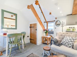 a living room with a couch and a table at Clarence Cottage - Uk47494 in Waterfall