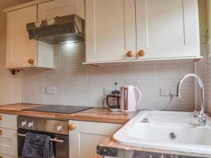 a kitchen with a sink and a counter top at Sea Dog Cottage in Scarborough +13 photos