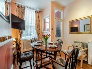 a kitchen and dining room with a table and chairs at Sea Dog Cottage in Scarborough