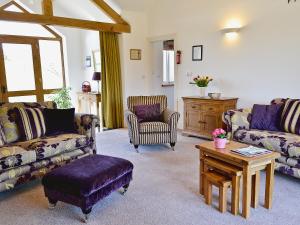 a living room with couches and a coffee table at Swallows Nest in Soulby