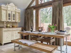 a kitchen with a wooden table and a large window at Lily Pad Lodge in Donington on Bain