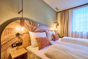 a hotel room with two beds and a wall at Hotel Karol in Vienna