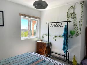 a bedroom with a bed and a window at CasaDaMeiaLuaArrifana in Aljezur +11 photos