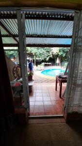 an open door to a patio with a swimming pool at Leopard Lily in Potchefstroom