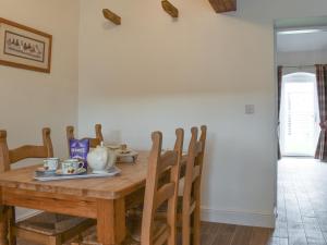 a dining room table with a tea set on it at Apple Tree Barn- Uk40791 in Church Minshull