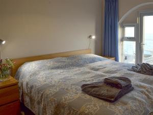 a bedroom with a bed with a pillow on it at 5 Coast Lodge in Pevensey
