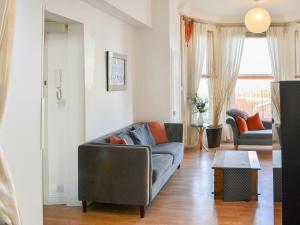 a living room with a couch and a table at Seagulls Studio in Bridlington