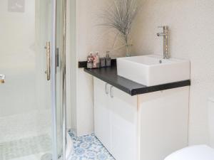 a bathroom with a white sink and a shower at Seagulls Studio in Bridlington +2 photos
