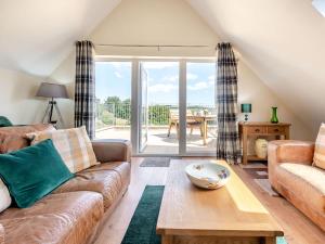 a living room with a couch and a table at Penceunant in Penuwch +32 photos