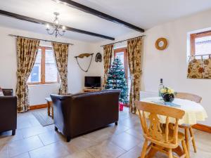 a living room with a christmas tree and a table and chairs at Lintel Barn - E5253 in Runcton Holme