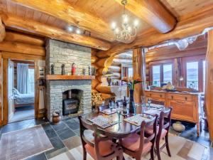 a dining room with a table and a fireplace at Molalatau Lodge in Lairg