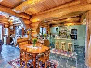 a kitchen and dining room with a wooden ceiling at Molalatau Lodge in Lairg +26 photos