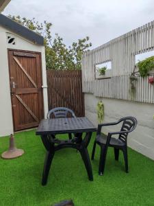 a picnic table and two chairs on the grass at Marula Guest House Unit 1 in Durban +5 photos