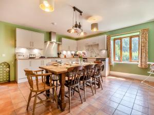 a kitchen with a large wooden table and chairs at St Mary's Chapel in New Buckenham +20 photos
