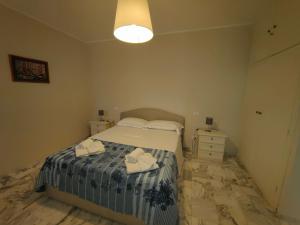 a bedroom with a bed with two towels on it at Iride in Portovenere +24 photos
