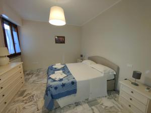 a bedroom with a bed with a blue and white blanket at Iride in Portovenere