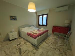a bedroom with a bed and a table and a window at Iride in Portovenere